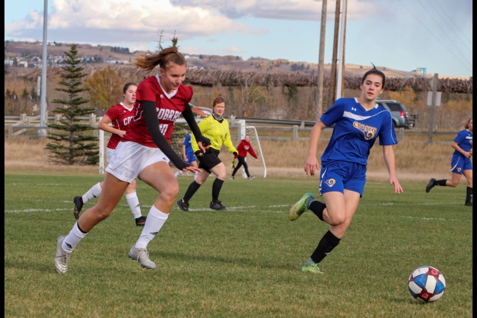 Amy Schmidtke with the Cochrane High Cobras girls soccer team chases the ball at Rangers Field in their final competitive game of the regular season against Airdrie's Bert Church Chargers on Oct. 8. The Cobras won the game 10-2. (Jessica Lee/The Cochrane Eagle)