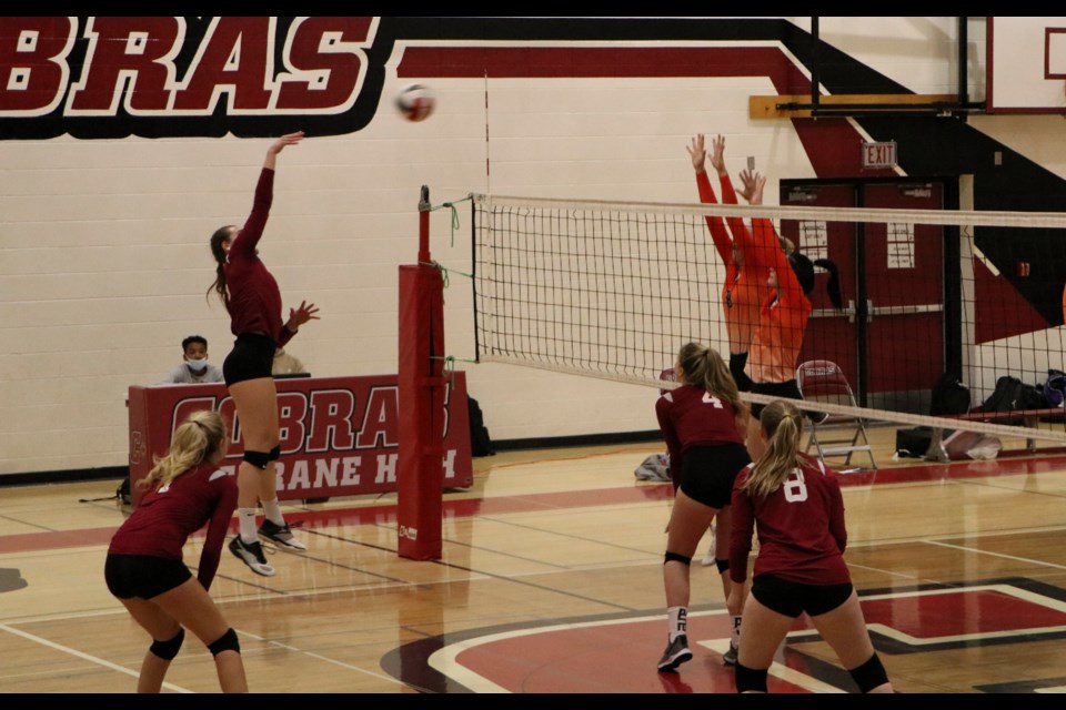 Cochrane Cobras sr. girls volleyball co-captain Faith Solecki drives the ball over the net toward the W.H. Croxford Cavaliers in a Cobras home game Monday (Oct. 18). The Cobras won the game with 3 out of 5 sets. (Jessica Lee/The Cochrane Eagle)
