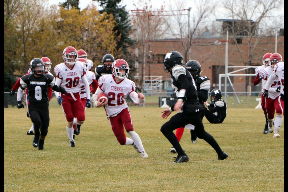 Cobras wide receiver Ethan Clazie dodges Mustangs players on his way upfield in the RVSA league final Oct. 29. Cochrane High won 28-21 over George McDougall in overtime. (Jessica Lee/The Cochrane Eagle)