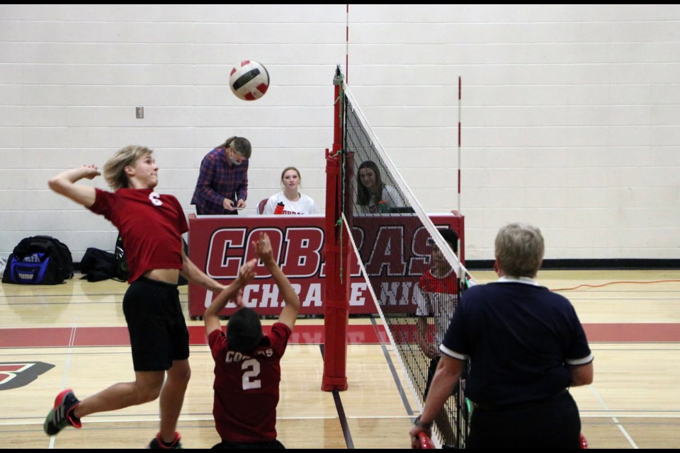 Cobras sr. boys volleyball setter Noah Visvanathan taps the ball up for defensive specialist Ray Belanger at the net in the RVSA divisional semi-final game at Cochrane High Nov. 9. (Jessica Lee/The Cochrane Eagle)