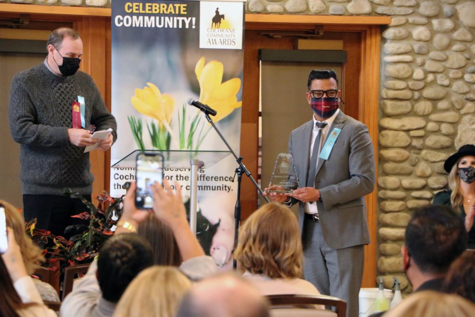 Jag Thind, owner of Mehtab East Indian Cuisine, accepts the award for Business of the Year at the 2021 Cochrane Community Awards held at the RancheHouse Nov. 28. During the pandemic, Mehtab was offering free food to anyone in need. (Jessica Lee/The Cochrane Eagle)