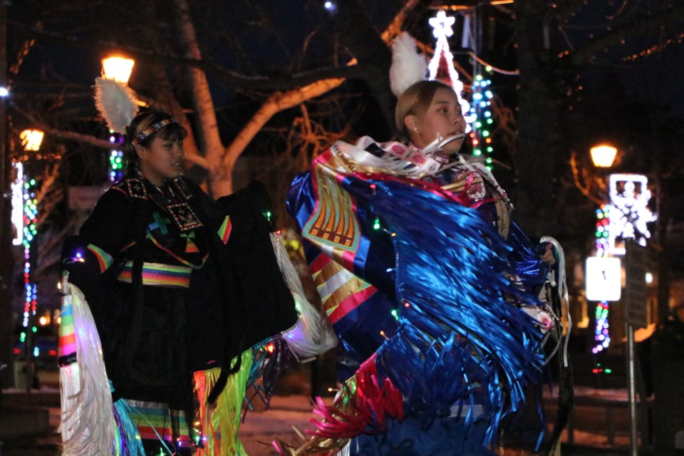 The Mini'Thni Dancers perform in their regalia, modified to include colourful holiday lights, at the Cochrane Light Up kick off Dec. 4. (Jessica Lee/The Cochrane Eagle)