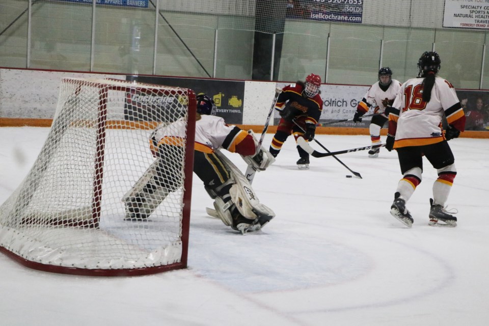 Chaos forward Sarah Gaiser lines up a shot in front of the Calgary Titans net. Gaiser had two out of five goals for the Chaos in the Dec. 17 match at Spray Lake Sawmills Family Sports Centre. (Jessica Lee/The Cochrane Eagle)