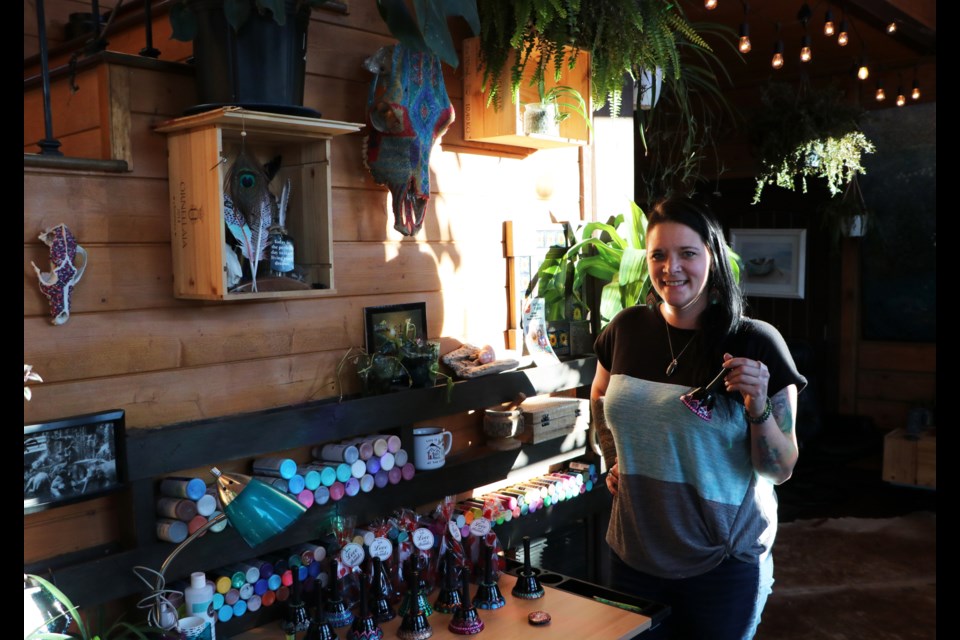 Chelsea Summer stands next to her home studio where she paints hand paints love bells with mandalas. (Jessica Lee/The Cochrane Eagle)