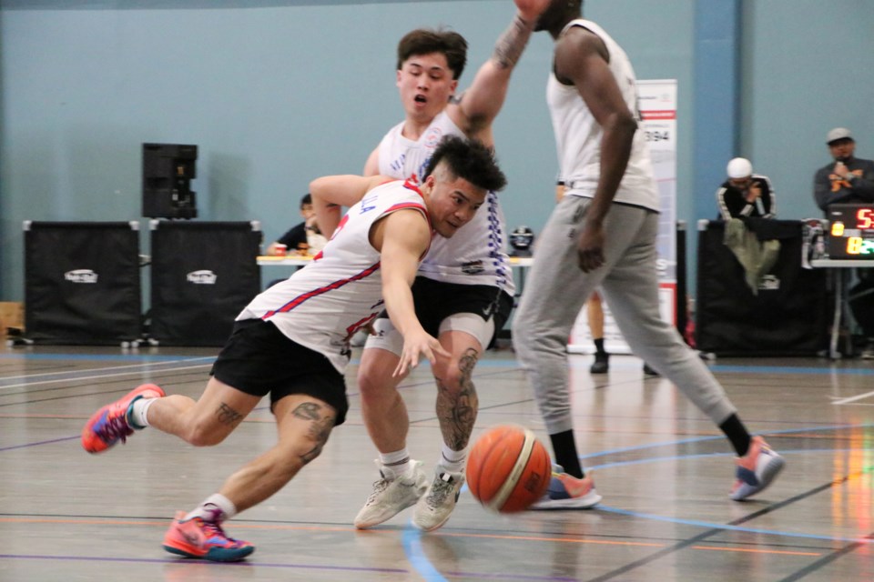 Canmore Deja vu's Harold Padilla tries to push past a player from High River's East-West College in in a match-up at Cochrane Basketball League's three-on-three tournament at Spray Lake Sawmills Family Sports Centre April 17. (Jessica Lee/The Cochrane Eagle)