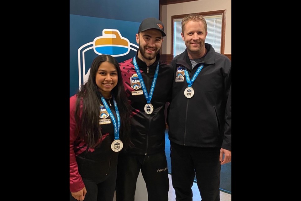 The mixed curling doubles team of Subasthika Thangadurai, left, and Ky Macaulay won provincials at the U21 Alberta championship in Edmonton over the weekend, coached by Gord Copithorne. (Photo Submitted)