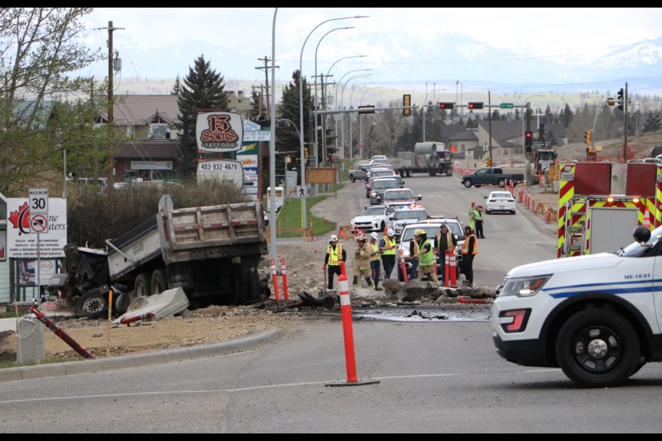 A large westbound dump truck crashed into a car and concrete barricades at the bottom of the Highway 1A hill, near Centre Ave. May 24. (Jessica Lee/The Cochrane Eagle) 