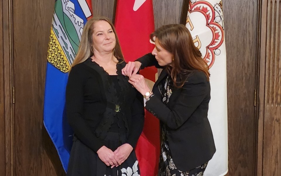 Third-generation bronze worker and Cochrane Native, Karen Begg, receiving a provincial medal on Nov. 21 for her contribution to the field of art.