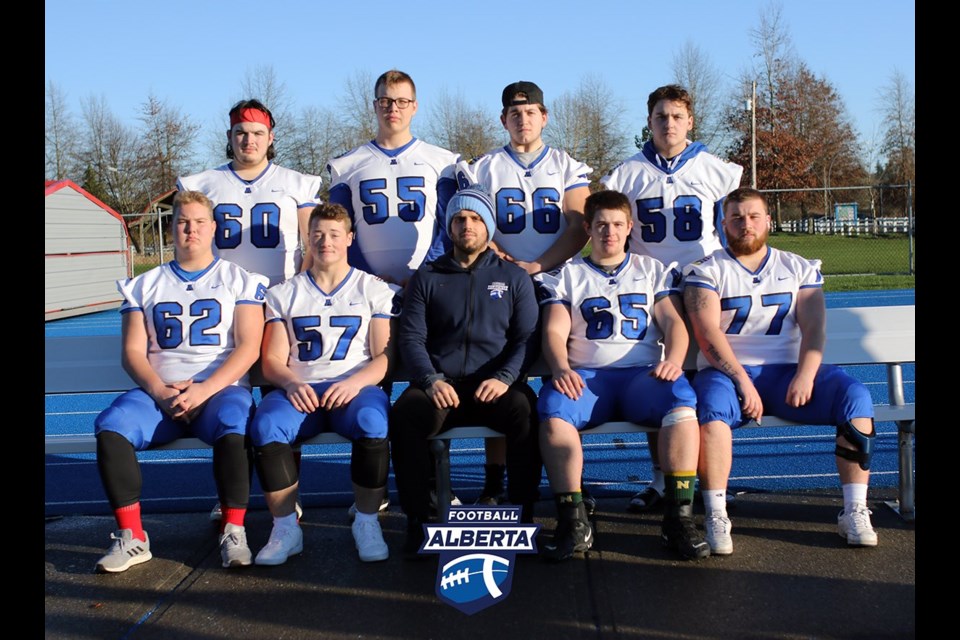 Grade 12 Cochrane Cobras centre Jacob Patterson, top right, gathers for a photo with his Team Alberta U18 offensive lineman teammates and coach Bryce Hughes at McLeod Athletic Park in Langley, B.C. (Football Alberta/Twitter)