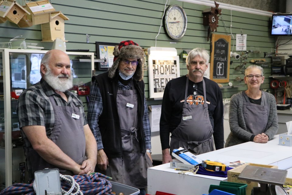 Volunteers Alec Godkin, Lynn Pickup, Tom Miller and store assistant Celine Beaulieu stand behind the Home Reno Heaven store counter Jan. 3. (Jessica Lee/The Cochrane Eagle)