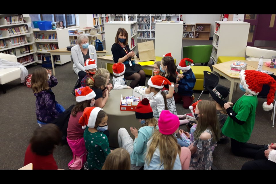 Glenbow students, their teacher and a member of the Rotary Club of Cochrane work on Christmas cards for seniors as part of their first EarlyAct project with the Rotary Club. 