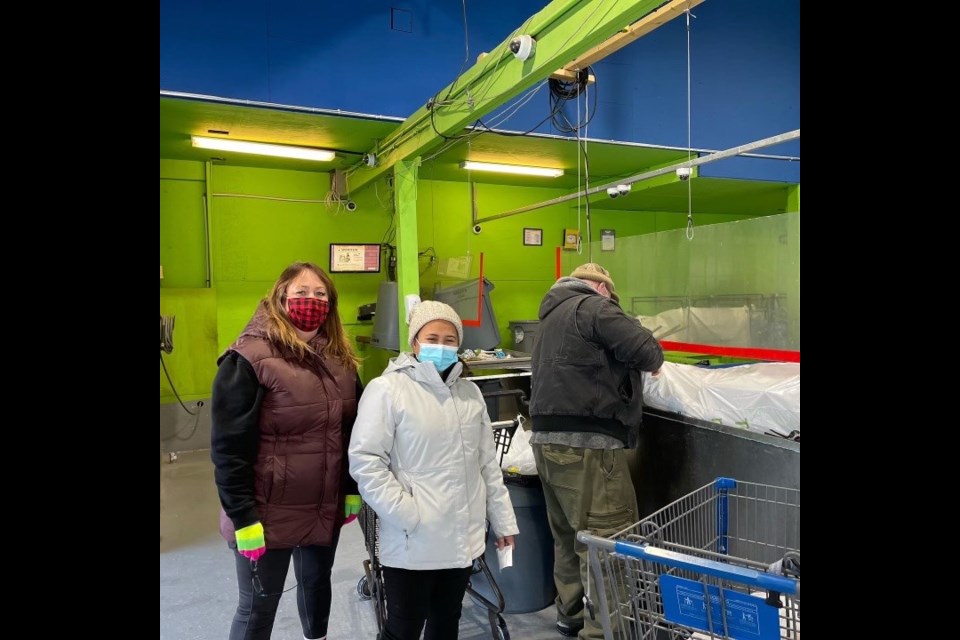 Samantha Casselton, left, and Lezley Rillera volunteer to collect and bring recyclables from the child care bottle drive to the Cochrane Bottle Depot. (Photo Supplied/Paul Singh)