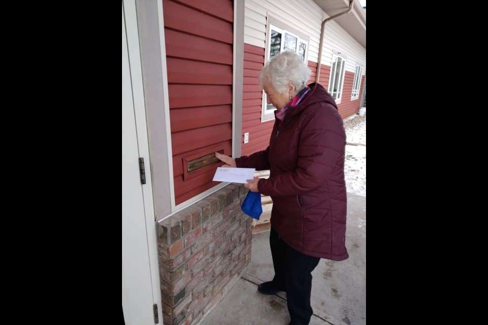 Cochrane Home Treasures board director Barb Primeau drops off a $2,000 donation at the Cochrane and Area Humane Society in the name of the Betty White Challenge. (Photo Supplied/Facebook)