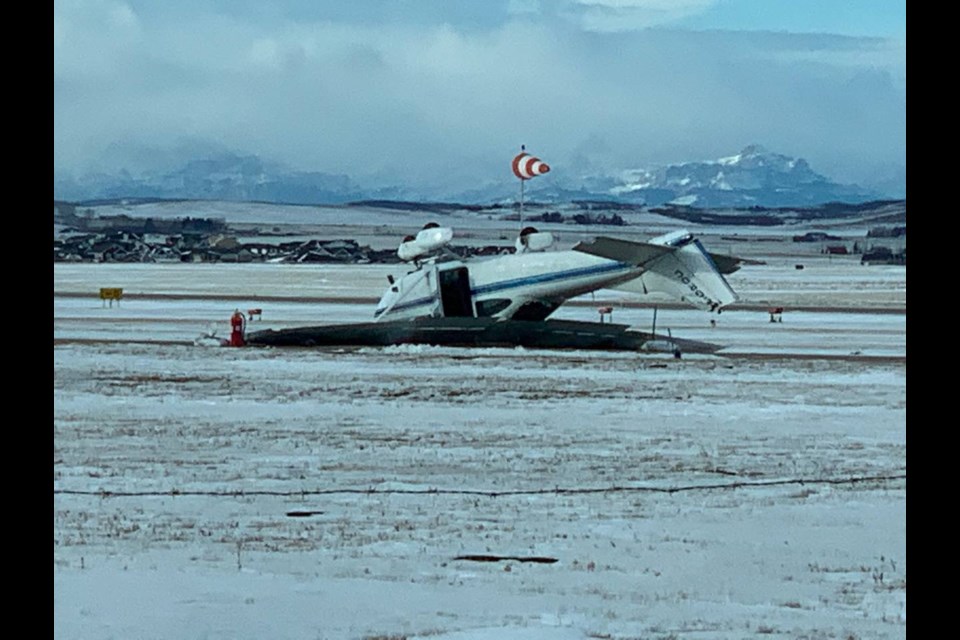 A privately-owned Cessna 182 being operated by its pilot was swept up by a wind gust and flipped over on the taxiway of the Springbank Airport Jan. 11. (Twitter/Joss Engen)