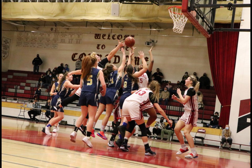 The Bobcats and Cochrane Cobras fight for the ball after a rebound on Bow Valley's net Feb. 2. (Jessica Lee.