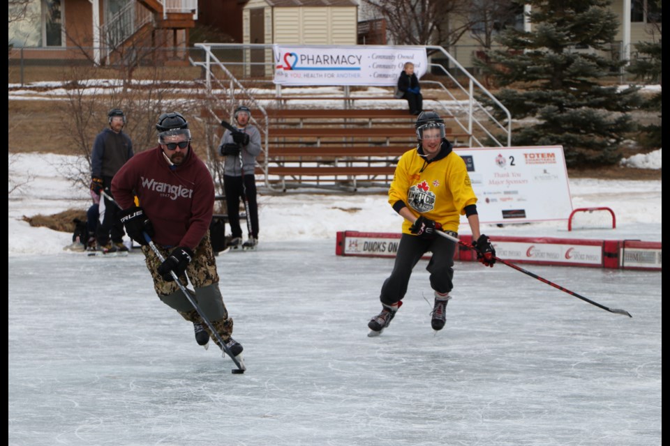 The Dekes of Hazzard (shirts) go toe to toe with the Cochrane Cruisers (yellow) in a quarterfinal playoff game at the 14th annual Kimmett Cup. (Jessica Lee/The Cochrane Eagle)