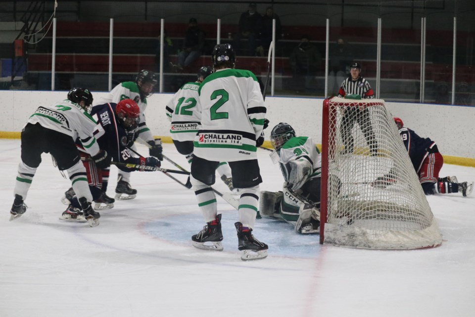 Cochrane Generals centre Shane Benoit takes a shot on Rocky Rams goalie Devon Caroll in the first of a seven game semi-finals playoff series at Cochrane Arena Feb. 16. (Jessica Lee/The Cochrane Eagle)