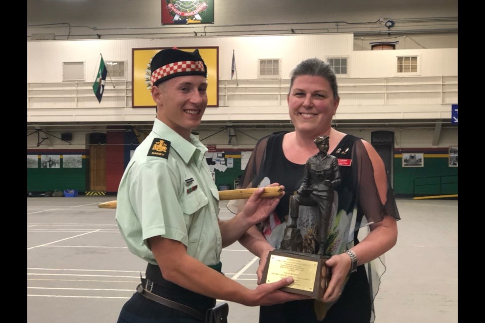Kara Hughes, right, presents cadet Chief Warrant Officer Bergerman-Twan of the 2137 Highlanders Royal Canadian Army Cadets with the President's Trophy in 2019 — an award given to the top cadet in Alberta. (Photo Submitted)