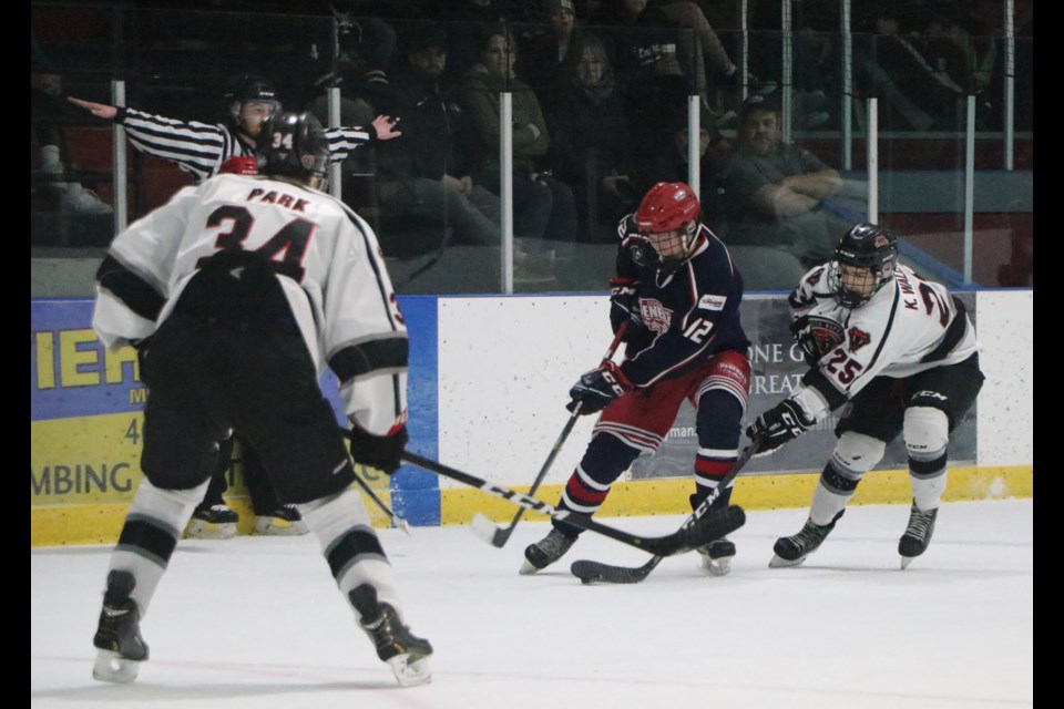 Red Deer Vipers Kyle Wallace comes from behind to try and steal the puck from Gens Jordan Butz in Game 5 of the north division final at the Cochrane Arena March 3, 2022. (Jessica Lee/The Cochrane Eagle)