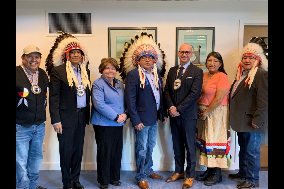 Councillor Anthony Bearspaw of Bearspaw First Nation, left, Bearspaw Chief Darcy Dixon, town councillor Susan Flowers, Chiniki Chief Aaron Young, Cochrane Mayor Jeff Genung, Wesley First Nation councillor Krista Hunter, and Wesley Chief Clifford Poucette gather for their first monthly CEDI meeting at the Stoney Tribal Administration building March 15. (Photo Supplied/Town of Cochrane)