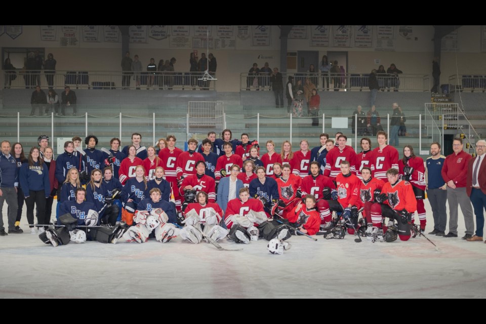 Students from Bow Valley and Cochrane High pose for a team photo at Spray Lake Sawmills Family Sports Centre for the Cochrane Classic Hockey Game March 23. (Photo Submitted/Mark Reece)