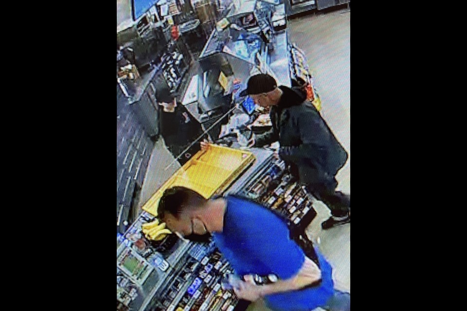 Cochrane RCMP are searching for the two vehicle theft suspects seen in this photo taken from video footage at a local business. (RCMP)