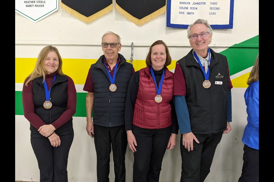 Jim Anderson, left, Herb Smith, Bob Jennings and Gary Hawkes win the gold medal in men's curling at Alberta 55 Plus Winter Games. (Photo Submitted)