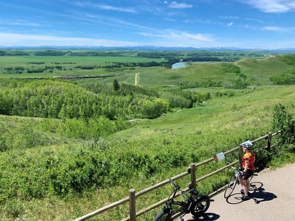 Glenbow Ranch Provincial Park sign and cyclist