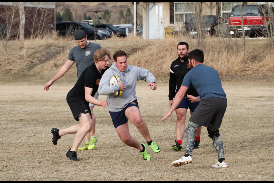 The Bow Valley Rugby Club Grizzlies men's team takes to the pitch at Mitford Ponds April 26 for their first outdoor practice of the season, led by head coach Tyler Hawes. (Jessica Lee/The Cochrane Eagle)
