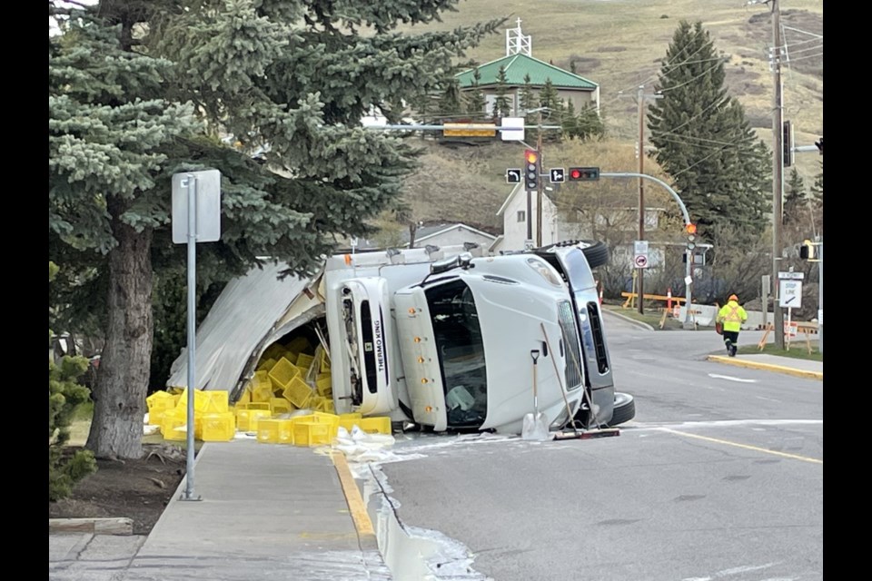 A truck carrying dairy products is tipped over on 4 Ave. W in Cochrane May 20. (Jessica Lee/The Cochrane Eagle)