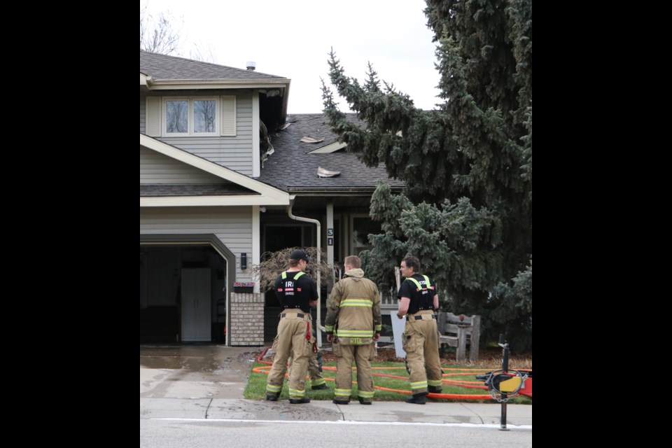 A home on Riverview Drive in Cochrane lit on fire in the late morning of May 23. (Jessica Lee/The Cochrane Eagle)