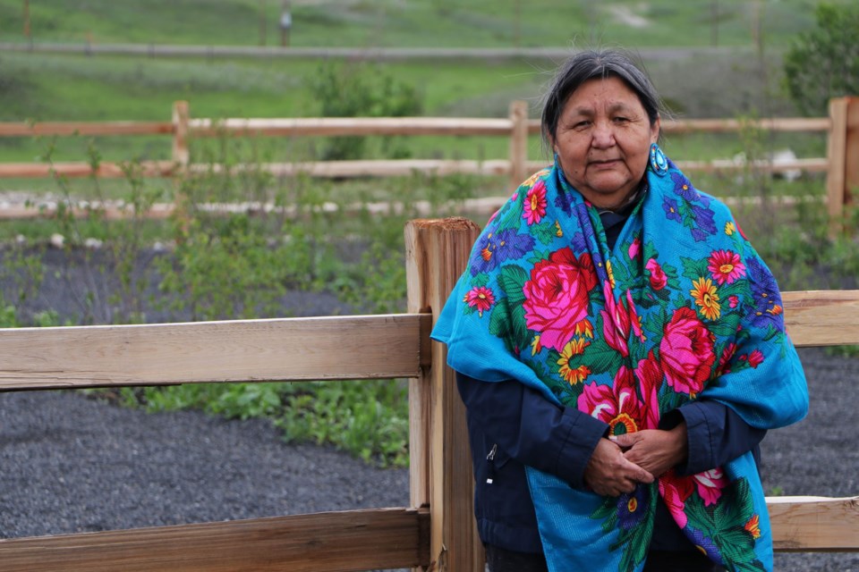 Jeanette Wildman, cultural liaison with Stoney Health Services, stands beside the new traditional healing space being constructed in Morley, near the Wesley Elders Lodge on June 24. (Jessica Lee/The Cochrane Eagle)