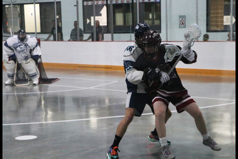 A Rockyview Silvertips player tries to manoeuvre past the Manitoba Blizzard's defence in the Cochrane team's last regular game of the season at Spray Lake Sawmills Family Sports Centre July 9. (Jessica Lee/The Cochrane Eagle)