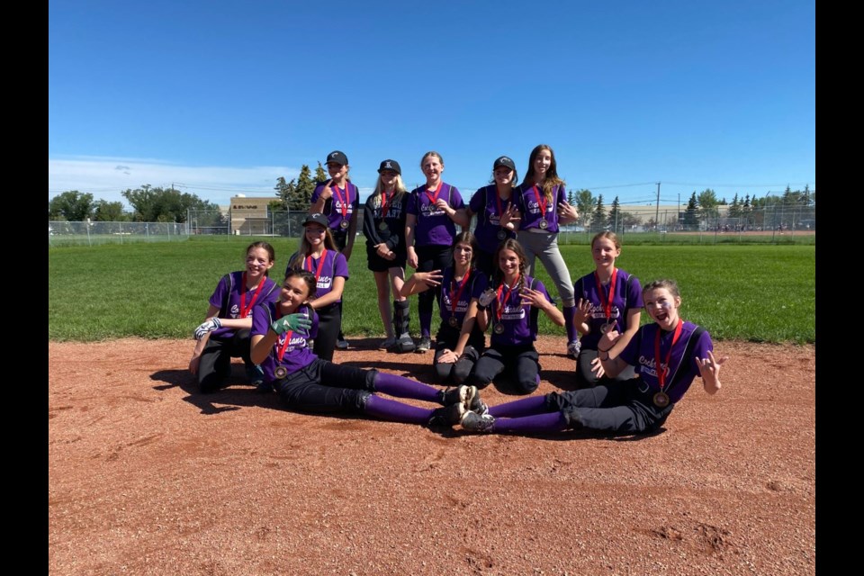 The Calgary Minor Ball U13 Cobras softball team won the gold medal at the Calgary Minor Softball City Championships in their final game of play July 9. It's the team's third consecutive gold medal win at the tournament. (Photo Submitted/Cochrane Minor Ball)