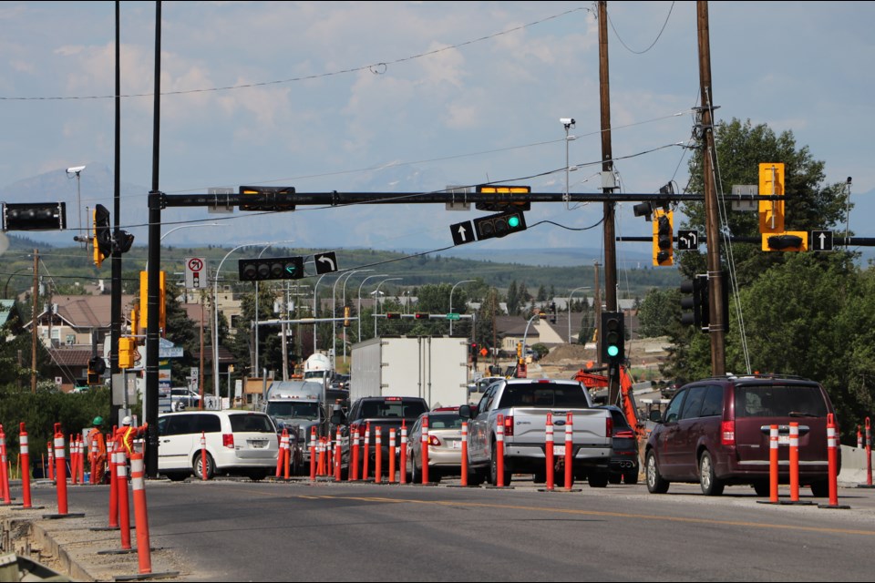 Beginning Monday (July 25), the old traffic light and wooden poles at the intersection of Highway 1A and Centre Avenue will be removed in preparation to realign traffic on the Highway.  (Jessica Lee/Cochrane Eagle)