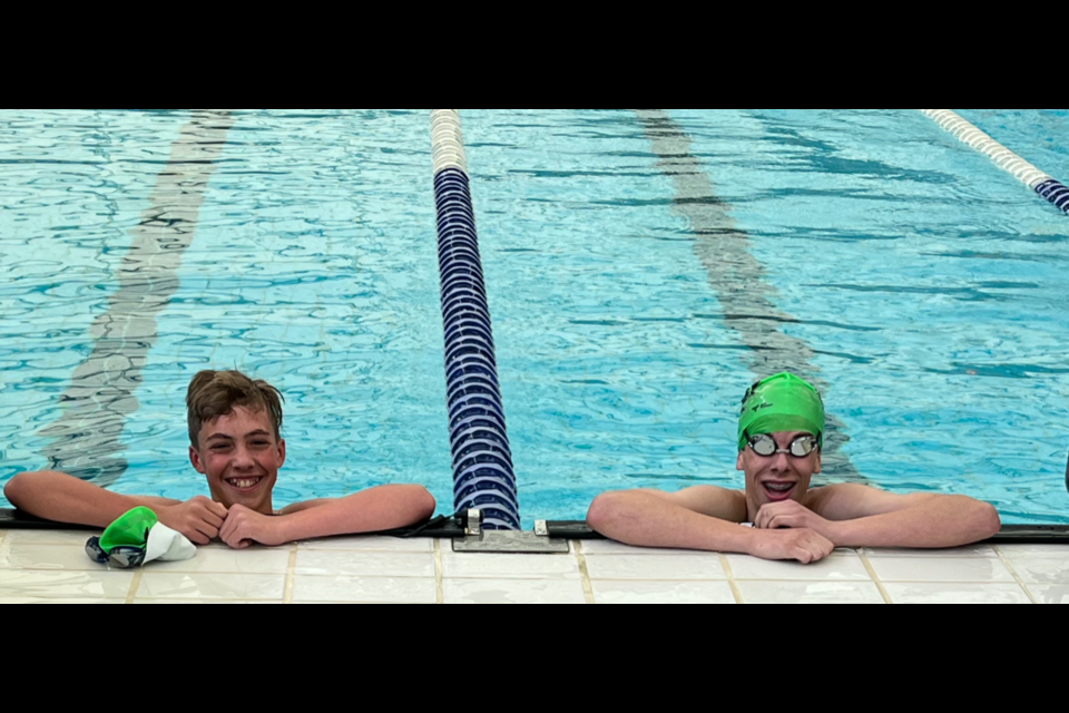 Caebri Smith, left, and Isaac Thibodeau pose for a photo in the pool after the 800-metre freestyle final at the Alberta Summer Swimming Association regionals competition at the MNP Community and Sport Centre in Calgary. Smith placed first with a time of 11:04.44 while Thibodeau came in second with a time of 11:30.03. (Photo Submitted)