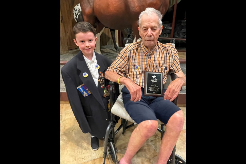 Liam Jackson, left, and his great-grandfather, Stan MacPhail, a veteran of the Second World War take a photo with Liam's Alberta Great Kids Award presented to him at the RancheHouse July 30. (Photo Submitted)