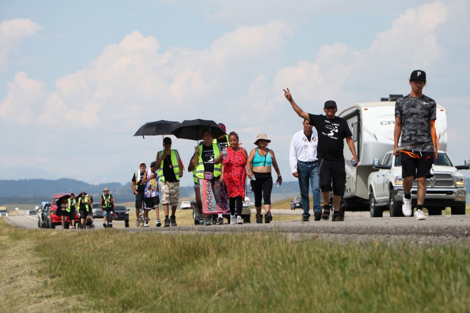 About 20 walkers from various First Nations are taking part in a walk from Mînî Thnî to Calgary and back called Ama'hnabino, which translates to They Are Taking Me Home. The walk aims to bring home the spirits of those lost in the city to addiction, overdose, suicide and violence. (Jessica Lee/Cochrane Eagle)