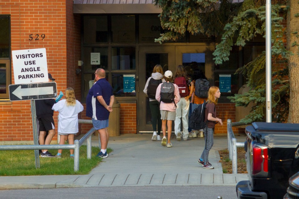 A group of students return to Cochrane High School for the first day of the 2022-23 school year on Sept. 1. 