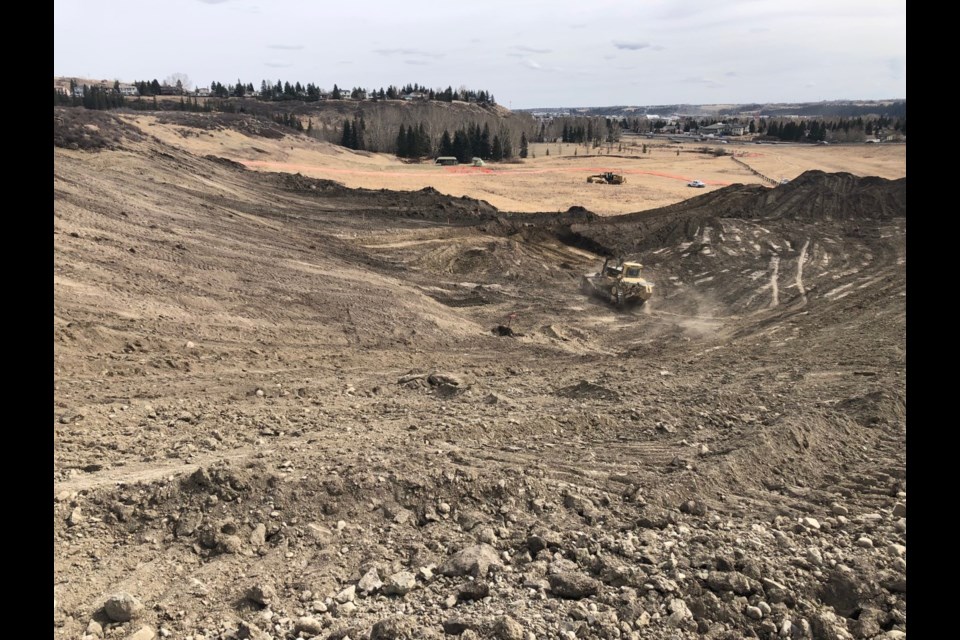 A dozer strips the top layer of soil in preparation of the construction of the northbound on ramp at intersection of highways 1A and 22 last week.
