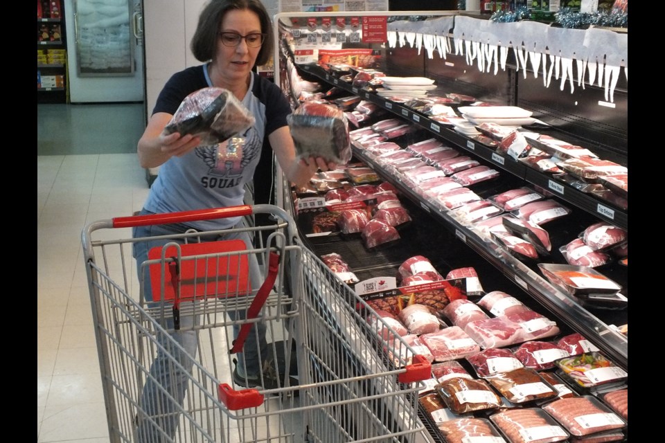 Jenny Hoops homes in on the meat section in her 50 second spree at Bragg Creek Foods.