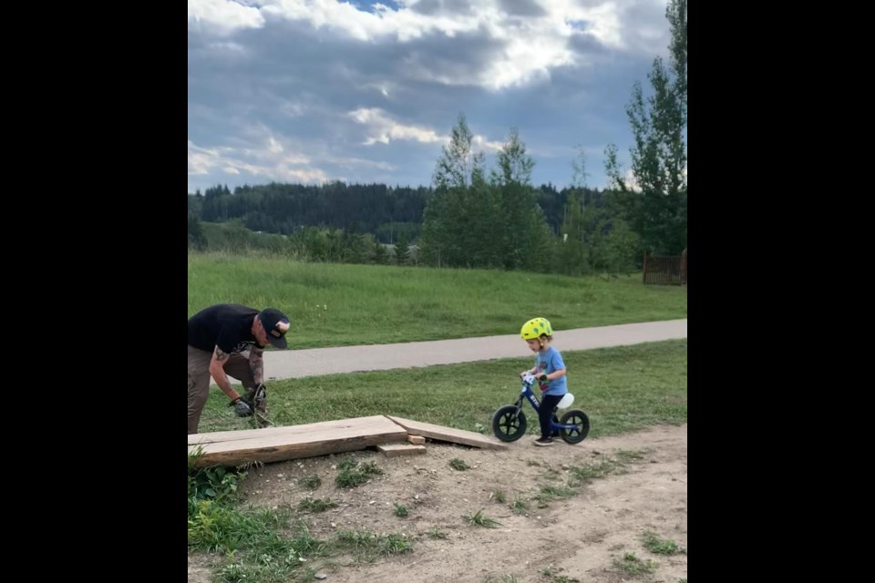 Lenny Yates waits for his dad to build a ramp at Riverfront Park