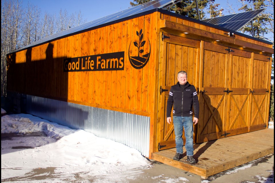 Chad Randal, sustainable farmer and owner of Good Life Farms Inc., standing beside the closed environment systems.