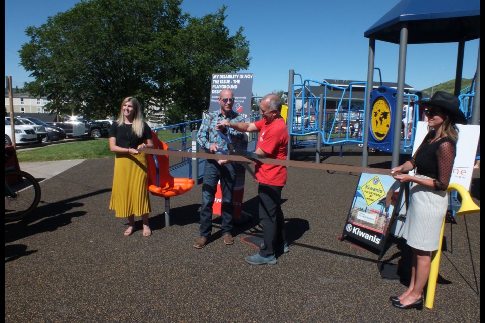 Cochrane Mayor Jeff Genung and Larry Horeczy of Variety – the Children’s Charity of Alberta open the playground at Centennial Park.