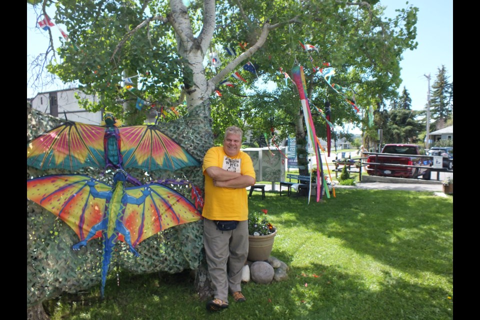Will Hawkins poses beside the latest addition to his display on Ross Avenue in Cochrane