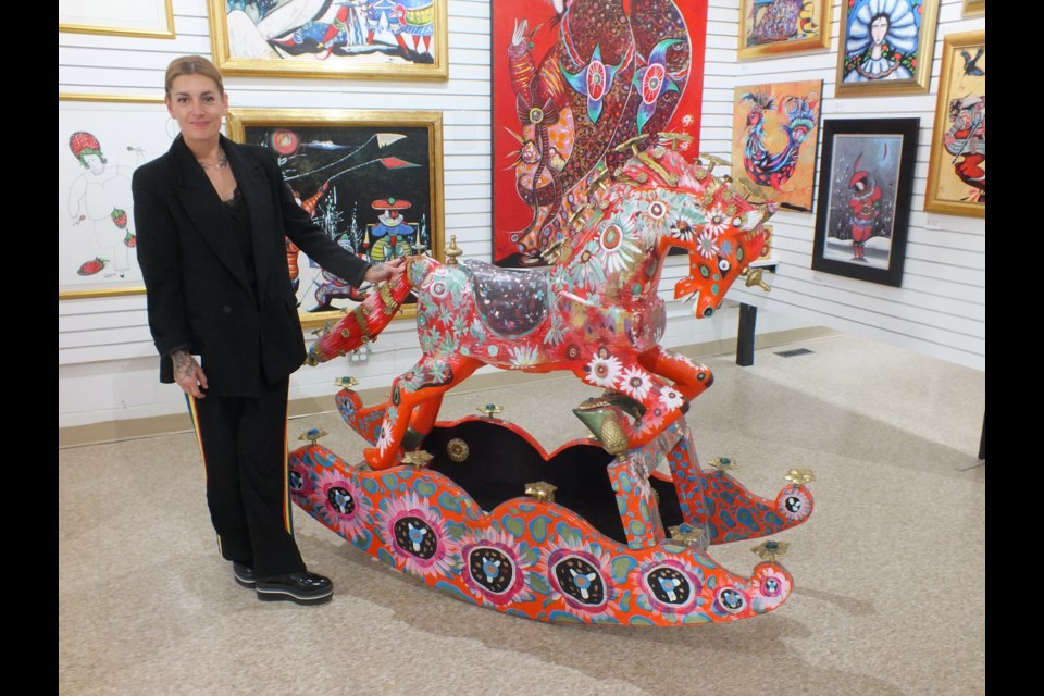 Art Evolution Gallery Manager Beau Curtis with a Toller Cranston creation.