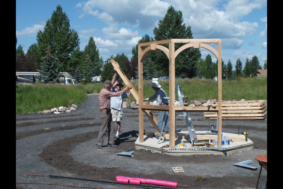 Dave Armstrong, Karl Gibbie, and Orville Lammle (average age 81) erect the gazebo at the centre of the labyrinth near Spray Lake Sawmills Family Sports Centre (SLSFSC) July 27.