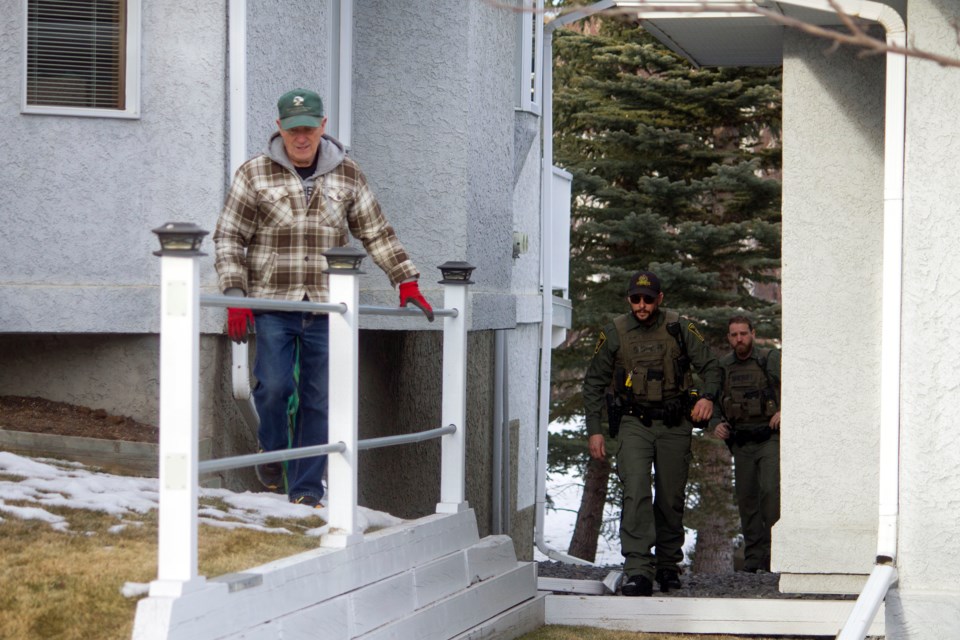 Alberta Fish and Wildlife officers leaving the scene where an injured deer was located after it was attacked in the early morning of Jan 10.