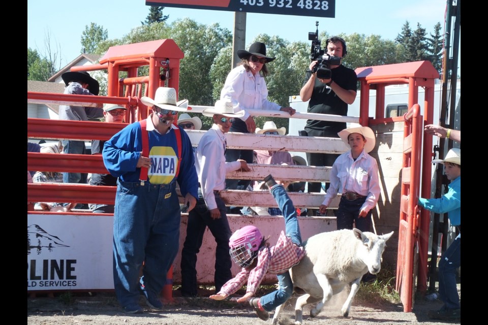 This mutton buster was legs akimbo just before hitting the dirt. No damage done.