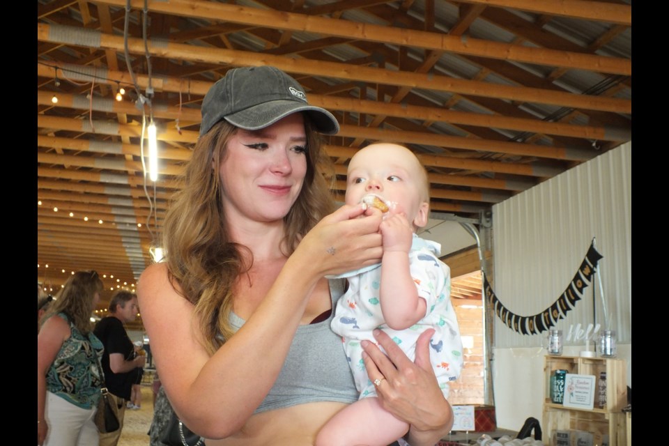 Nine-month-old Kade Kanaroski couldn't get mom Caitlyn to bring on the donut holes fast enough at the Cochrane Food Fest Sunday.